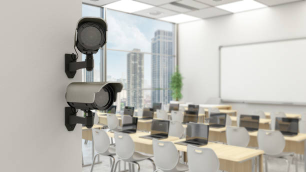 istock School Security Concept. Video Surveillance Cameras on Modern Classroom's Wall 2155982435