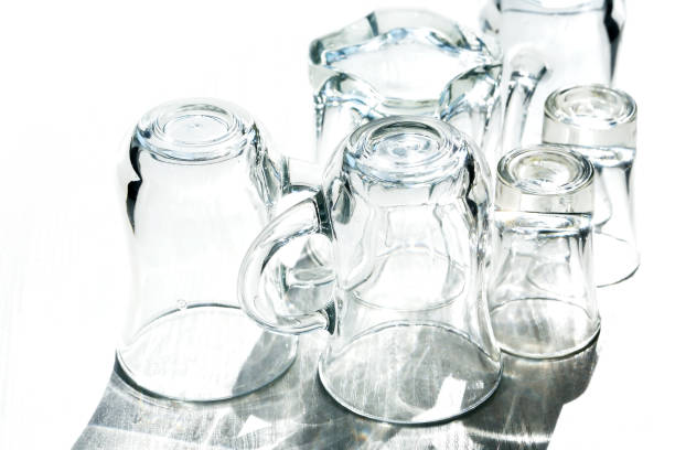 A set of clean dishes with long shadow on white background under sunlight