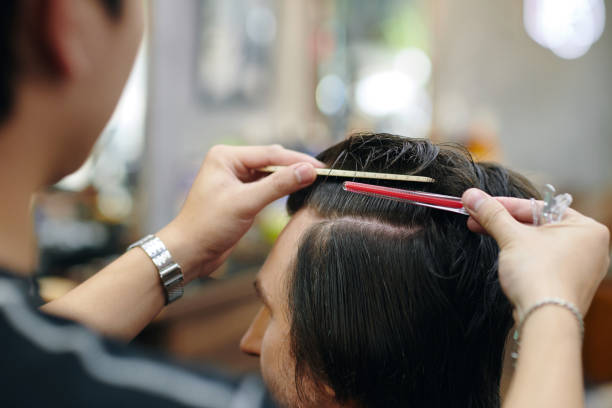 istock Man Cutting Hair of Client 2155983085