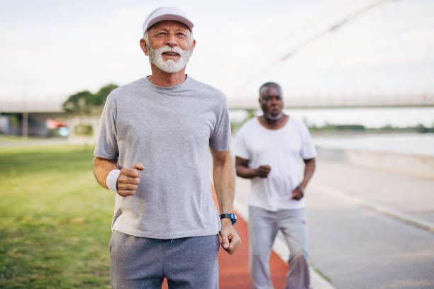 istock Two senior friends training together outside. Diverse Senior Man . 2155984537
