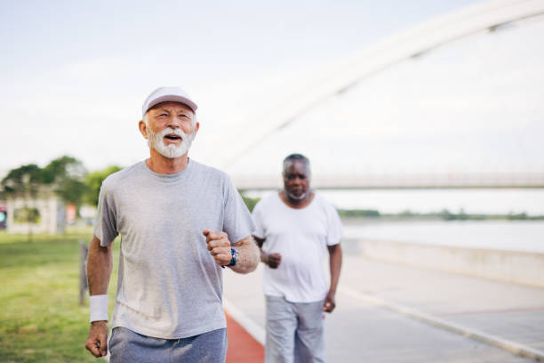 istock Two senior friends training together outside. Diverse Senior Man . 2155984579