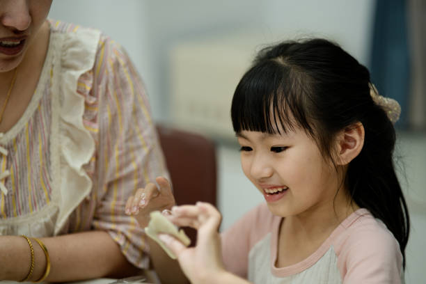 istock Mother and daughter are making dumplings at home 2155984679