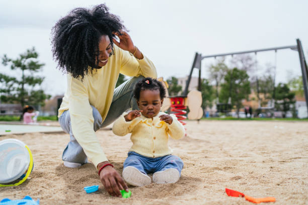istock A woman is playing with a child in a park 2155985646
