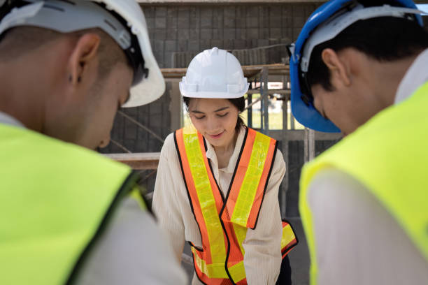 istock Asian female engineer with colleagues discussing construction plans, teamwork on-site 2155989046