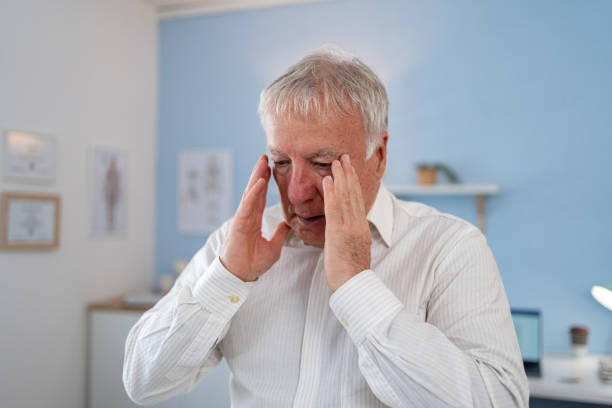 istock An elderly patient, suffering from a headache, is sitting and waiting for the next examination 2155990316