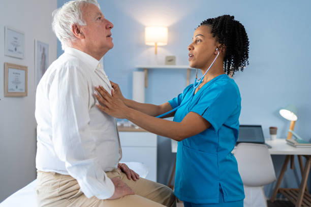 istock African American female Nurse uses a stethoscope while examining an elderly patient 2155990342