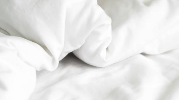 istock close up of  white bedsheet background ,good hotel service 2155991144