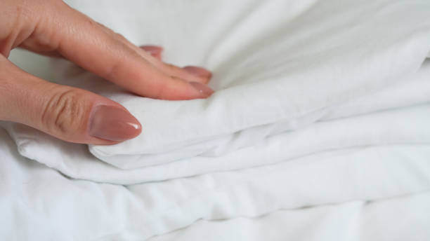 istock close up of  white bedsheet background ,good hotel service 2155991160