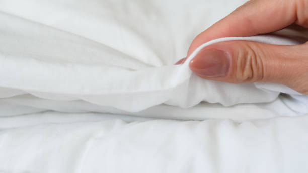 istock close up of  white bedsheet background ,good hotel service 2155991199