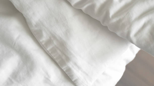 istock close up of  white bedsheet background ,good hotel service 2155991249