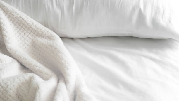 istock close up of  white bedsheet background ,good hotel service 2155991302