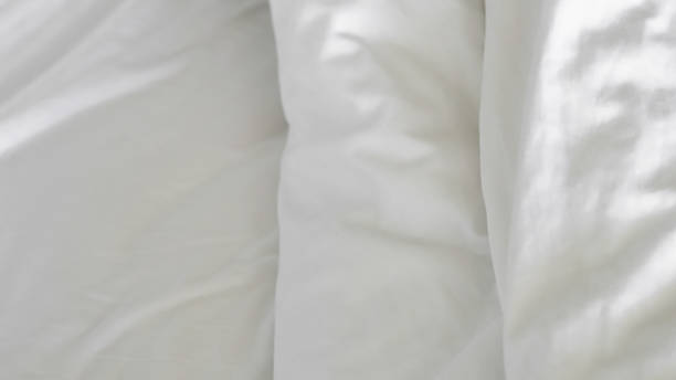 istock close up of  white bedsheet background ,good hotel service 2155991325