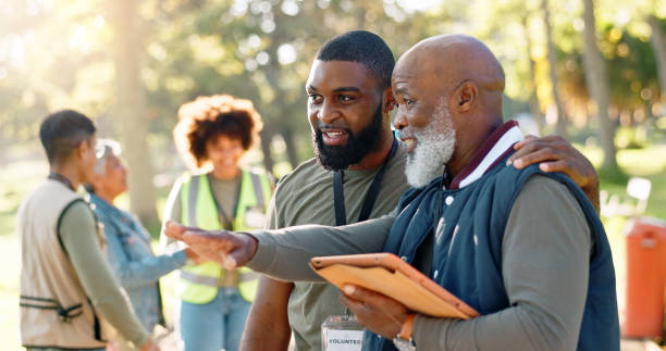 Cleanup, people and volunteers planning with tablet for support, community project or nature sustainability. Humanitarian, recycling or senior leader in charity service or NGO for park pollution