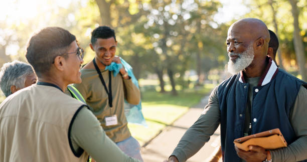 istock Park, people and volunteers handshake with tablet for support, community project or nature sustainability. Humanitarian, recycling or senior leader in charity service or NGO for pollution cleanup 2155992145