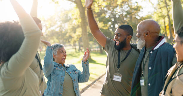 istock Park, people and volunteers celebration with high five for support, community project or nature sustainability. Humanitarian, recycling and climate in charity service or NGO for pollution cleanup 2155992148