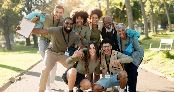 istock People, volunteer and happy together in nature, teamwork and environment sustainability project with group. Recycle, waste management and cleaning outside trash, help and ngo or community support 2155992154