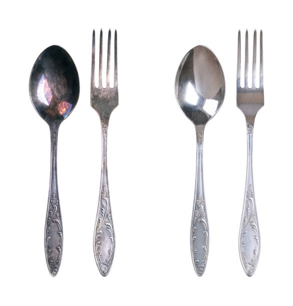 istock Sterling silver spoon and fork, tarnished and cleaned, isolated from above 2155992378