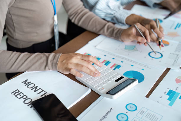 istock Business bookkeeper working with calculator to calculate business data summary report, accountancy document and laptop computer at the office 2155992380