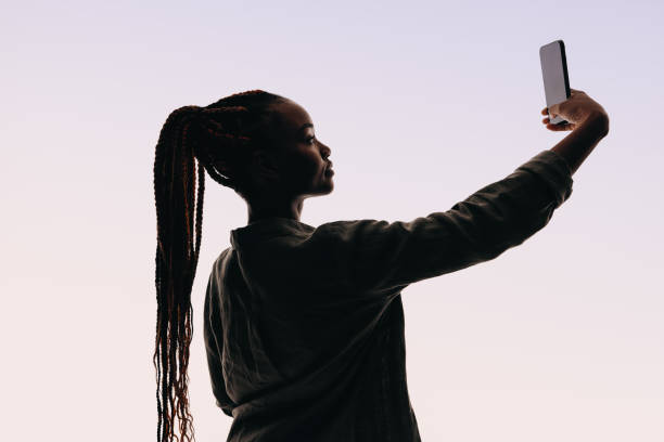 istock Confident gen z woman taking selfie with smartphone in studio 2155992940