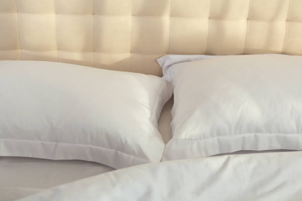 istock cotton bed linen white color in morning light 2155993525