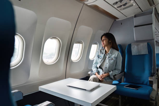 istock Asian people female person onboard, airplane window, looking at window while on the plane 2155993615
