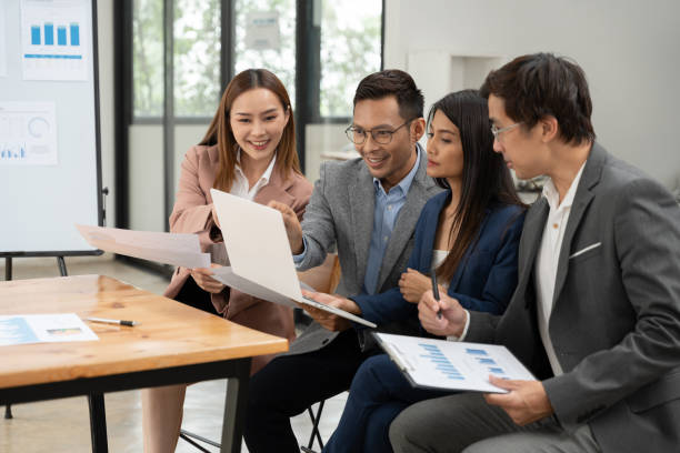istock Group of Asian businessmen are presenting graphs on a whiteboard. 2155994200