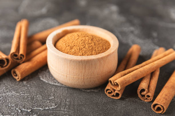 istock Cinnamon sticks on a textured wooden background. Cinnamon roll. Spicy spice for baking, desserts and drinks. Fragrant ground cinnamon. cinnamon powder Close-up. Place for text. copy space 2155994984