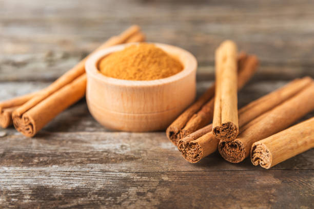 istock Ceylon cinnamon.Cinnamon sticks on a textured wooden background. Cinnamon roll and powder. Spicy spice for baking, desserts and drinks. Fragrant ground cinnamon. Close-up. Place for text. copy space 2155994992