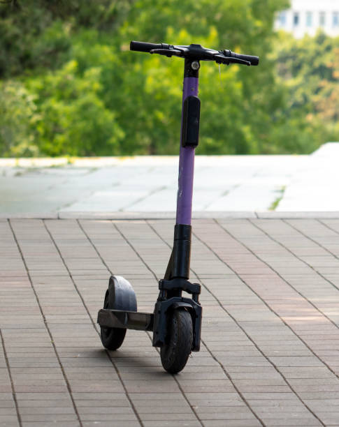 istock The scooter stands on the sidewalk in the park 2155995135