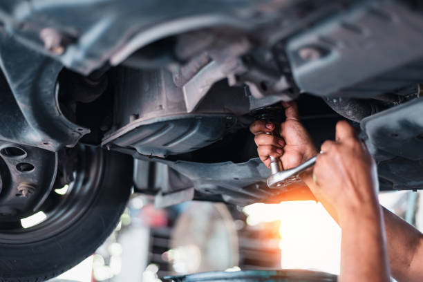 istock A mechanic in a garage repairs a car engine, oil-stained hands working with tools 2155996154