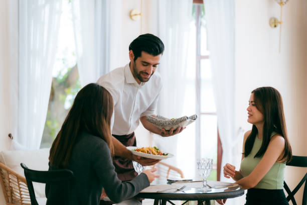 istock Engaging Service at the Eatery, Clients Enjoying Conversations while Waitstaff Attend, Cafe Scene Filled with Delicious Food and Beverages, Where Lifestyle Meets Business in Comfortable Dining 2155997531