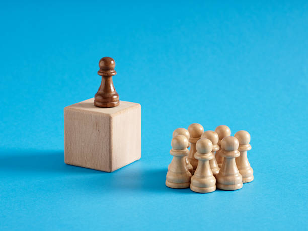 Leader or candidate chess pawn speaking to the crowd of audience.