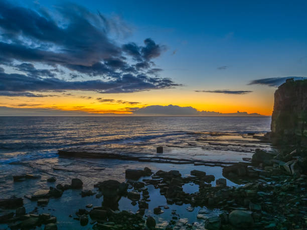 istock Sunrise over the ocean and rocky Inlet 2155998521