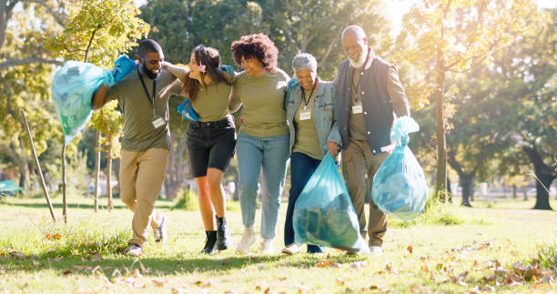 istock People, volunteer and happy with dirt clean at park with plastic bag for pick up, earth day and community service. Smile, waste collection and maintenance for environment, health and charity 2155998564