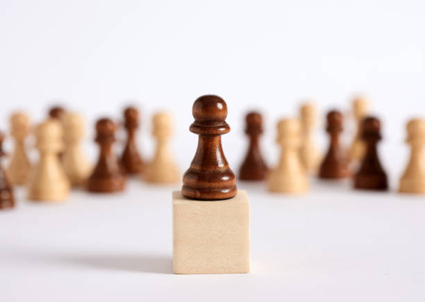 Chess pawn on the rostrum gives a speech to the crowded audience. Public speaking and political speech.