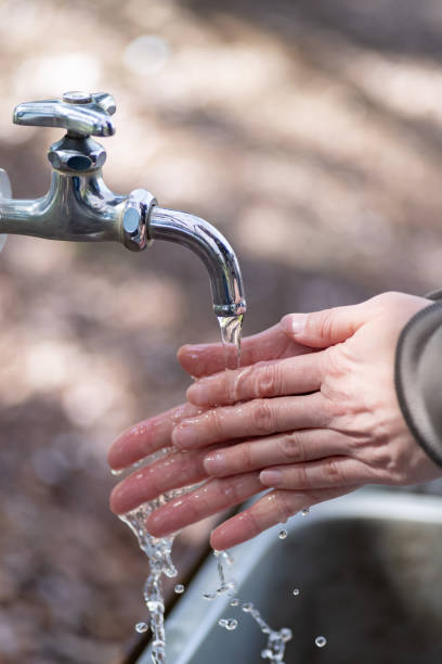 istock person washing hands outdoors 2156000313