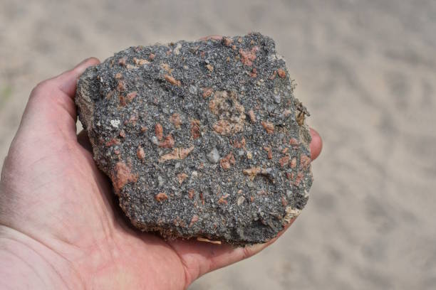 istock hand holding one large piece of black asphalt 2156000632
