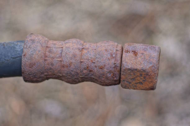 istock part of an old black plastic hose with a brown rusty iron nut 2156000864