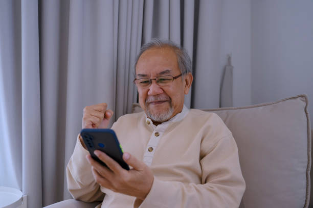 istock Senior man is using smart phone at home. 2156000877