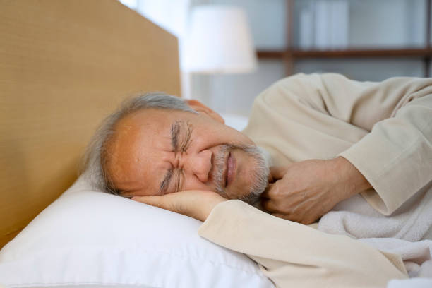 istock Senior man is sick and sleeping in bedroom. 2156000880