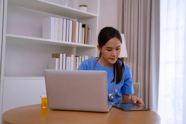 istock Female health care worker  is using digital device. 2156000907