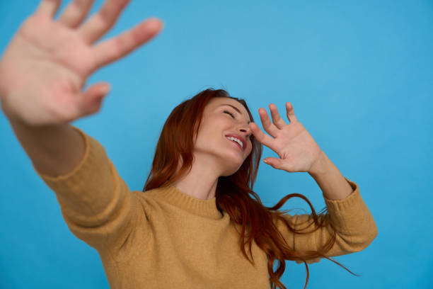 istock Woman covering her face laughing 2156001379
