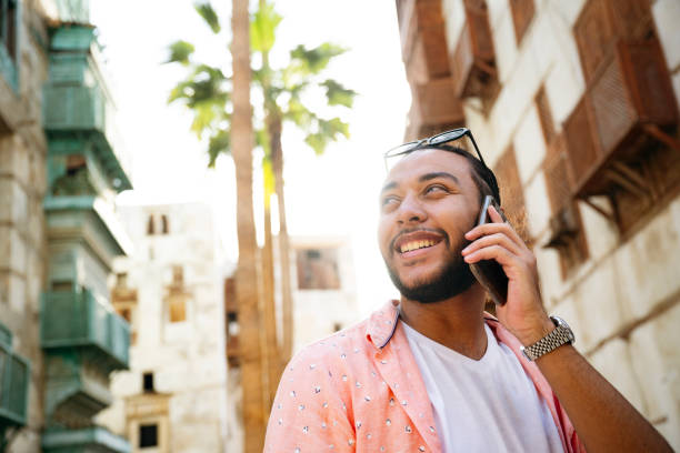 istock Smiling young Saudi man talking on his smart phone 2156001680