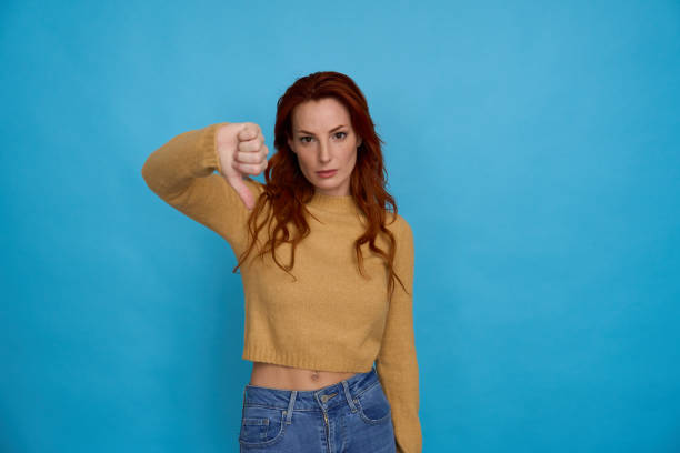 istock Woman showing disapproval with thumbs down 2156001834
