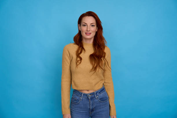 istock Smiling woman posing on blue background 2156001868