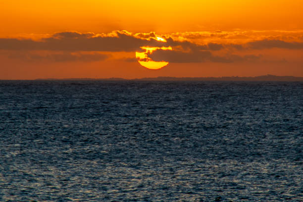 istock Beautiful dramatic and relaxing yellow and orange sunset with colorful clouds. 2156001883