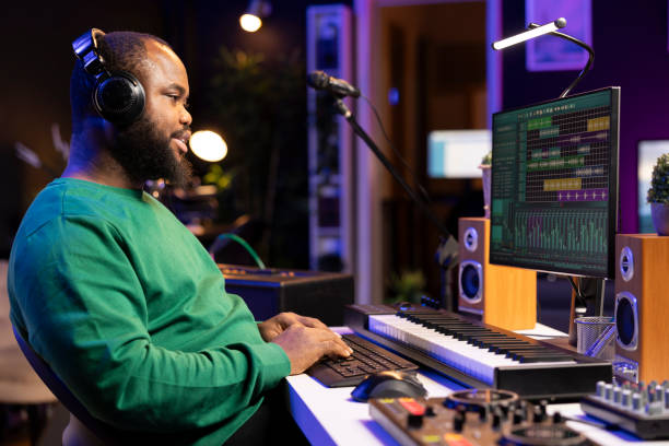 istock African american composer mixing and adding sounds on his recordings 2156001928
