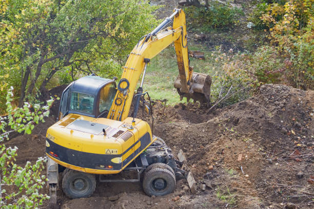 istock Yellow excavator begins to dig a pit 2156003300