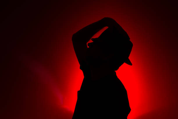 Hairless woman whose hair has fallen out due to chemotherapy she received in cancer treatment, shot with reverse light technique.