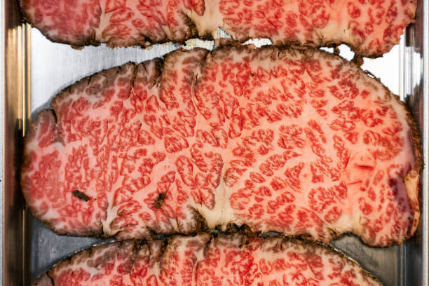 Dry-aged beef sliced with marbled texture. High quality Japanese Wagyu beef. Food ingredient concept.